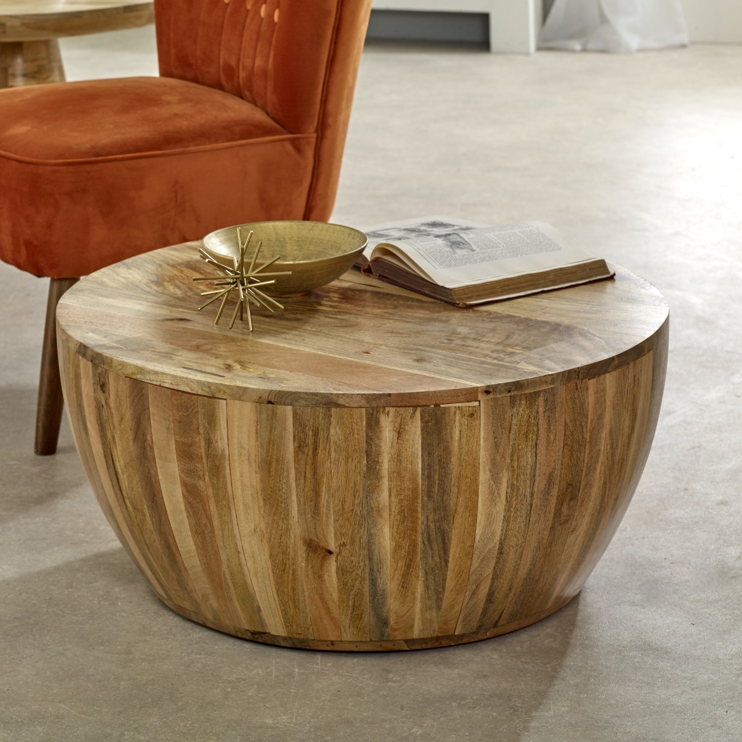 Merlin Mango Wooden Drum Coffee Table Wooden coffee table with decorative bowl and book in a living room setting