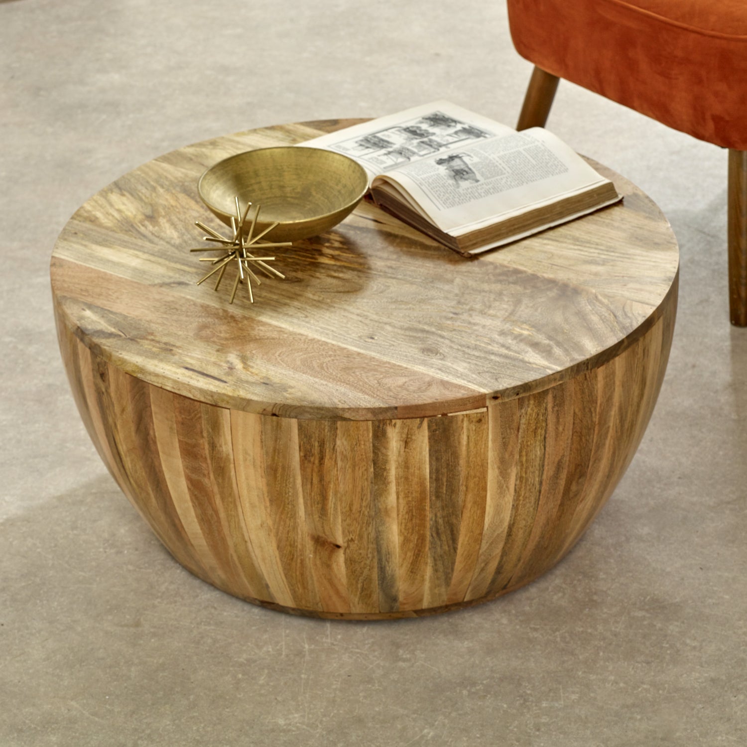 Merlin Mango Wooden Drum Coffee Table Round wooden coffee table with a gold bowl and book on a beige carpet