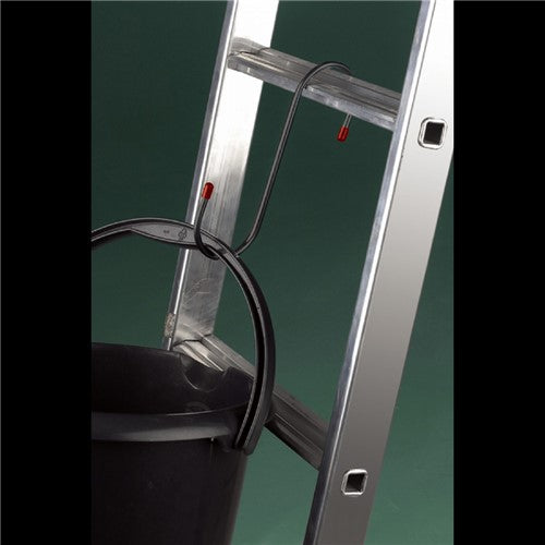 Metal ladder with a black cable on a green background