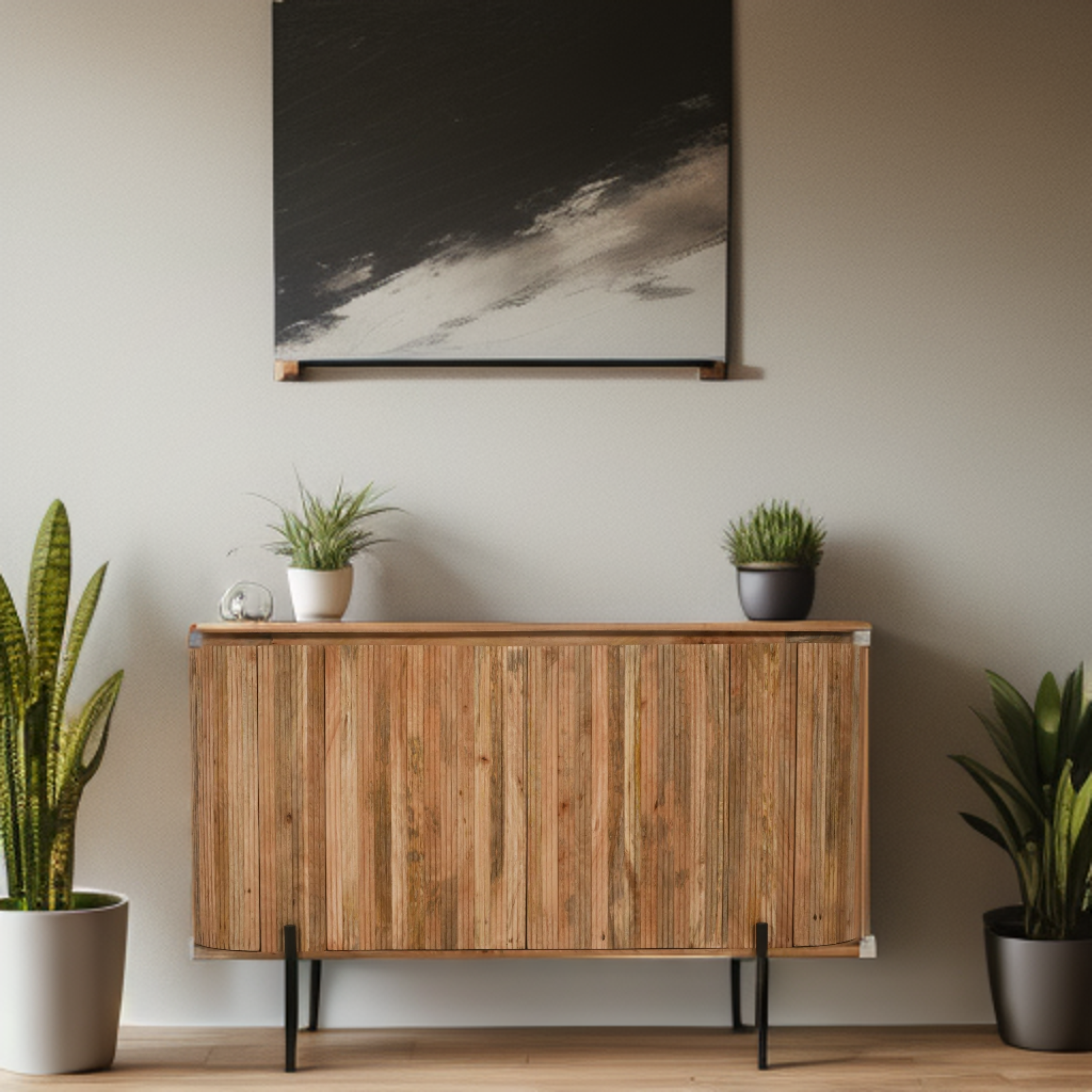 Wooden sideboard with potted plants against a neutral wall with a painting.